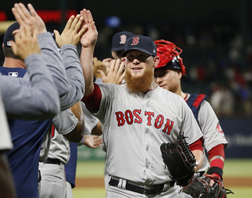 Boston Red Sox relief pitcher Craig Kimbrel is congratulated by teammates after the Red Sox defeated the Texas Rangers 6-5 Saturday in Arlington, Texas.