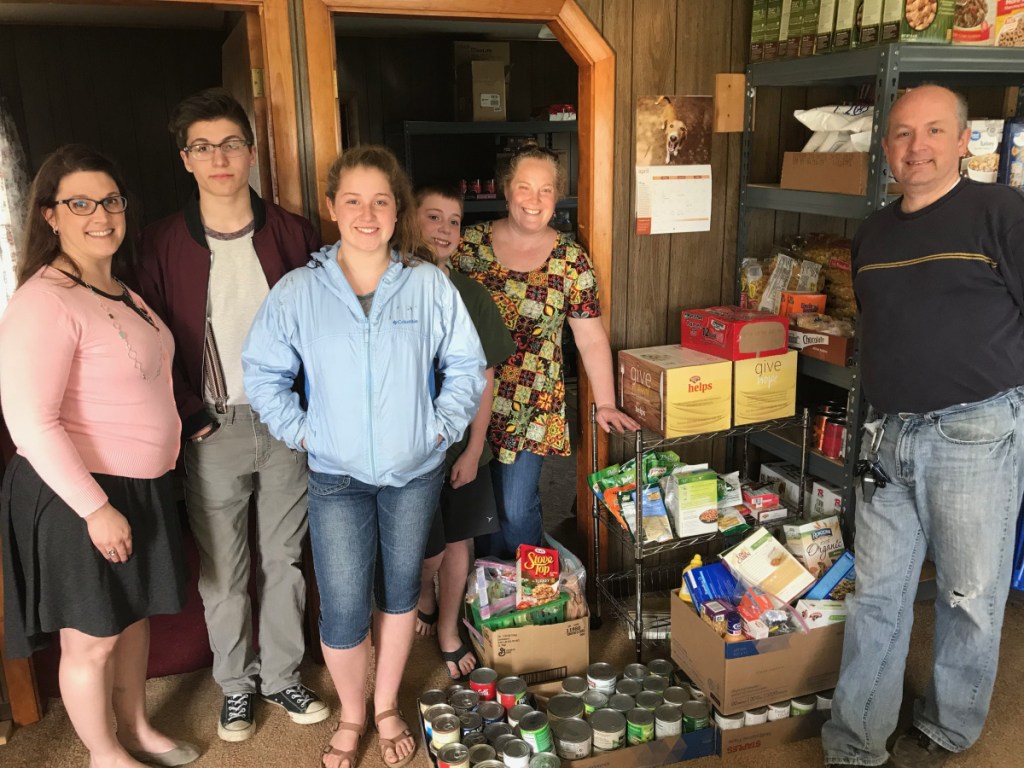 Snow Pond Arts Academy students. from left, Jess Crowell, Ethan Michaud, Kiara Hurley, Donovan Hurley, Melissa Hurley and Brian Hurley recently delivered 12 cases of food they collected during Spirit Week to the Sidney Food Bank located on West River Road in Sidney.