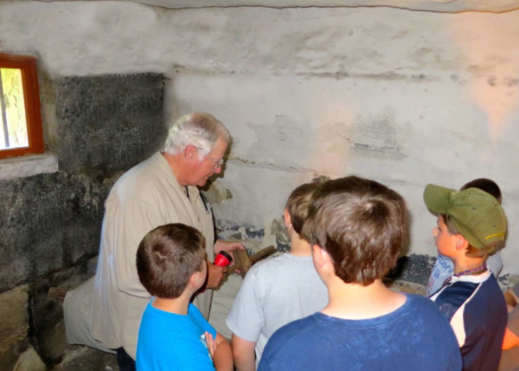Greg Shaw, a volunteer docent at the Old Jail in Wiscasset, helps young visitors imagine what it would like to be an inmate in the 1800s.