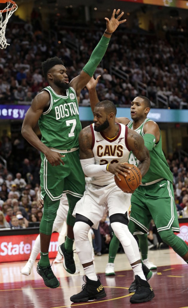 In this October 2017 photo, Cleveland's LeBron James (23) tries to get past Boston's Jaylen Brown (7) and Al Horford (42) in the second half of a gamein Cleveland. Although there were long stretches when it seemed impossible that the Cavaliers and Celtics would meet in the Eastern Conference finals, they're set to clash for the third time in four years.