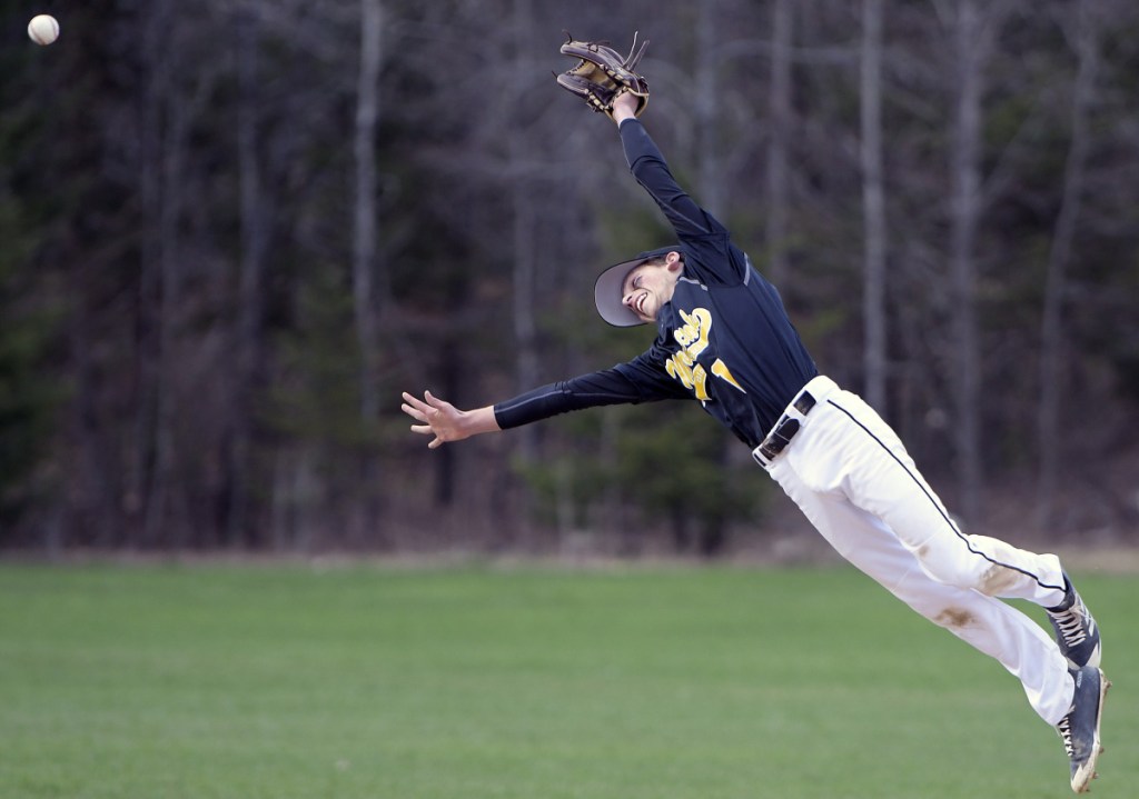Maranacook's Wyatt Lambert gets some air time jumping for a line drive against Lawrence during a Kennebec Valley Athletic Conference game Monday in Readfield.