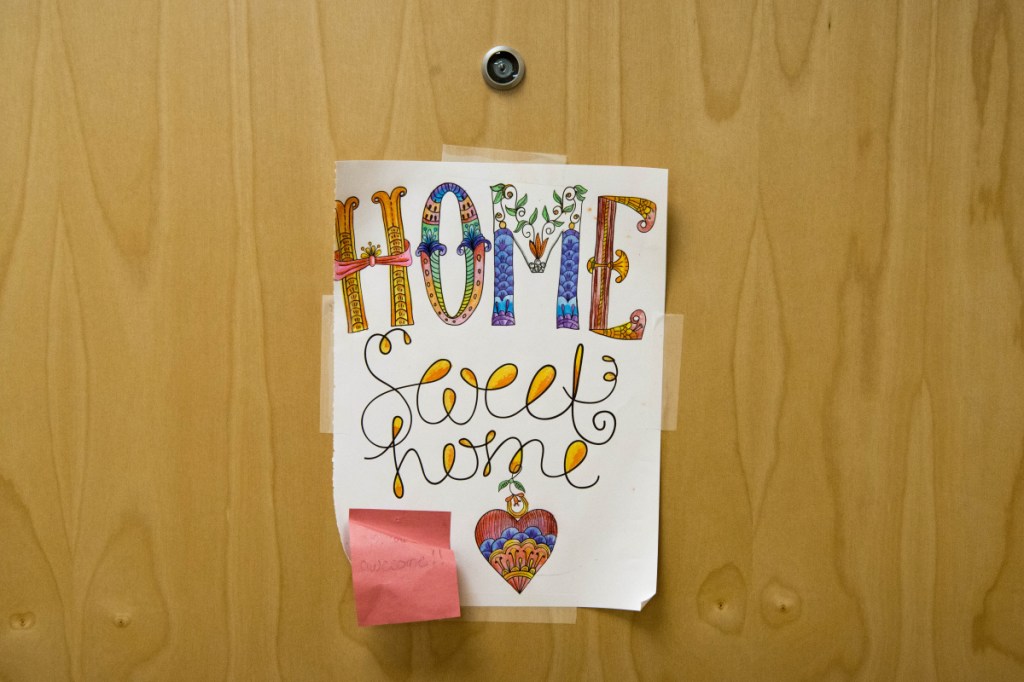 A sign hangs on the door Friday of one of the transitional apartments at the Mid-Maine Homeless Shelter in Waterville.