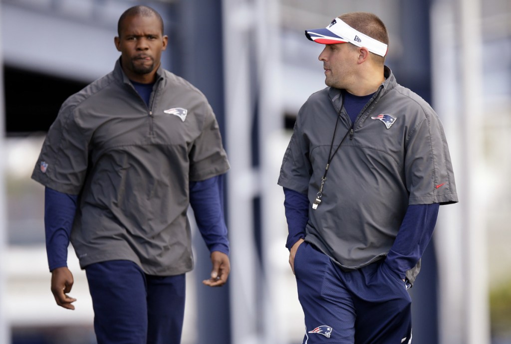 In this October 2014 photo, New England Patriots offensive coordinator Josh McDaniels, right, talks with safety's coach Brian Flores as they walk out to the field before practice begins at the team's facility in Foxborough, Massachusetts. It looked like the Patriots would be replacing both of their coordinators following February's Super Bowl loss to Philadelphia. McDaniels walked away from a deal to coach the Colts. But there will be a new look on defense, with Flores taking over play calling duties following defensive coordinator Matt Patricia's departure.