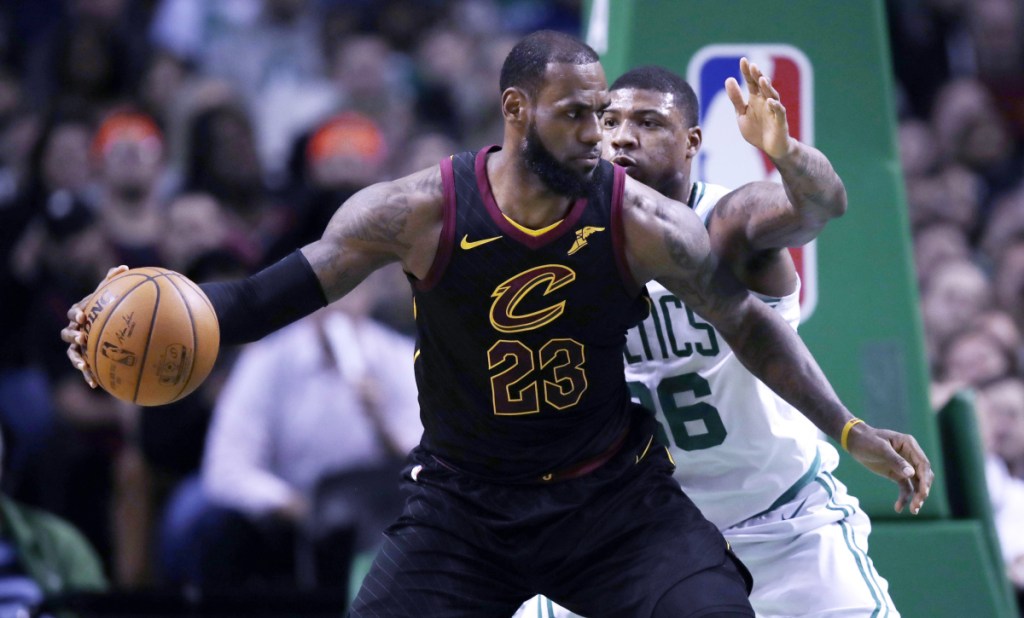 AP file photo
In this January photo, Cleveland Cavaliers forward LeBron James (23) works the ball inside during the second quarter of a game against the Boston Celtics in Boston. There haven't been any championship banners raised into Boston's hallowed rafters since 2008.
James won't let go of the rope. He has bounced the Celtics from the playoffs four times in the past seven years and Cleveland's megastar carries a six-game winning streak at Boston into this year's Eastern Conference finals, which open Sunday at TD Garden.