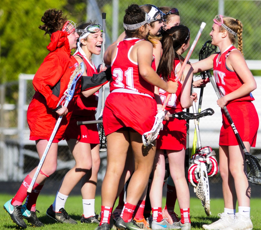 The Cony girls lacrosse team celebrates after beating Gardiner 13-9 Friday at Hoch Field in Gardiner.