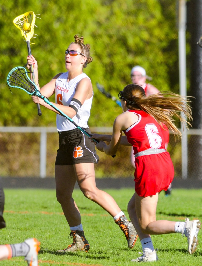 Gardiner's Anna Chadwick, left, passes as Cony's Sydney Avery defends during a game Friday at Hoch Field in Gardiner.