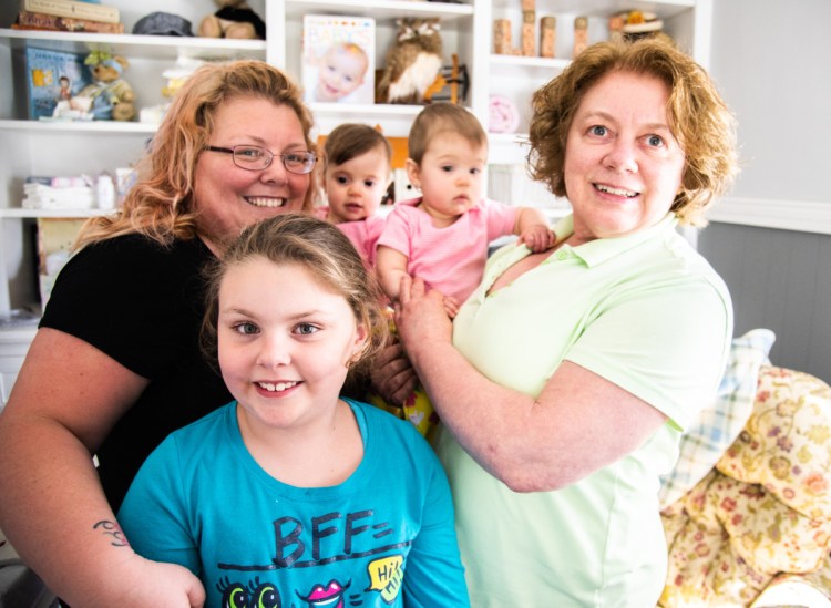 Lynn Merrill has taken care of her grandchildren and assisted her three adult children while getting her Bachelor of Arts degree from the University of Maine at Augusta. Here, the Augusta resident, far right, stands with her 10-month-old twin granddaughters, Charlie, left, and Sadie Duplessis, of Gardiner. They are joined, back left, by Merrill's daughter, Sarah Dyer, and granddaughter Chloe Dyer, 8, of Windsor.