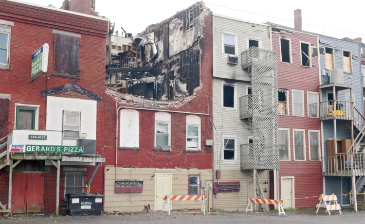The collapsed roof on 235 Water St. in Gardiner is seen Oct. 22, 2015, after the building was heavily damaged by a fire earlier that year. Gardiner officials are considering declaring the buildings dangerous after its new owner has done nothing to it.