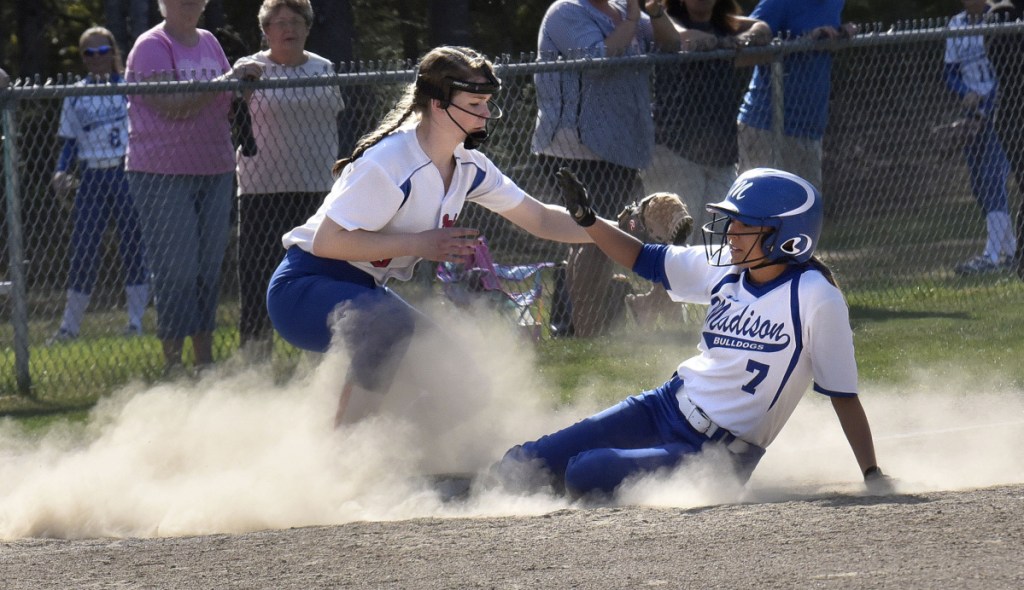 Madison senior Sydney LeBlanc slides into third base as Oak Hill infielder Julia Noel fields throw during a Mountain Valley Conference game Monday afternoon in Madison.