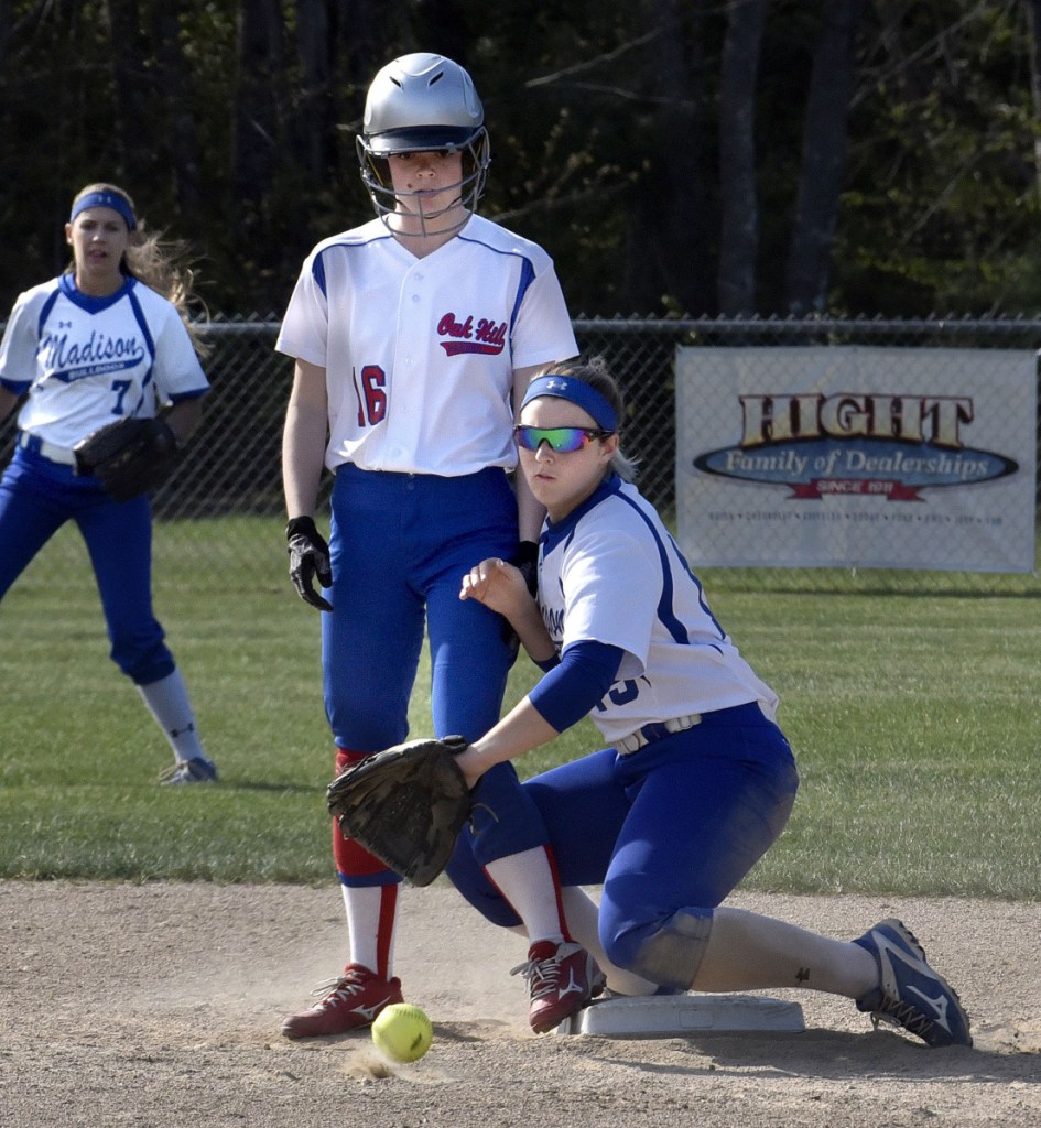 Oak Hill baserunner Rylea Swan makes it to second base as Madison's Marah Hall fields a throw during a Mountain Valley Conference game Monday afternoon in Madison.