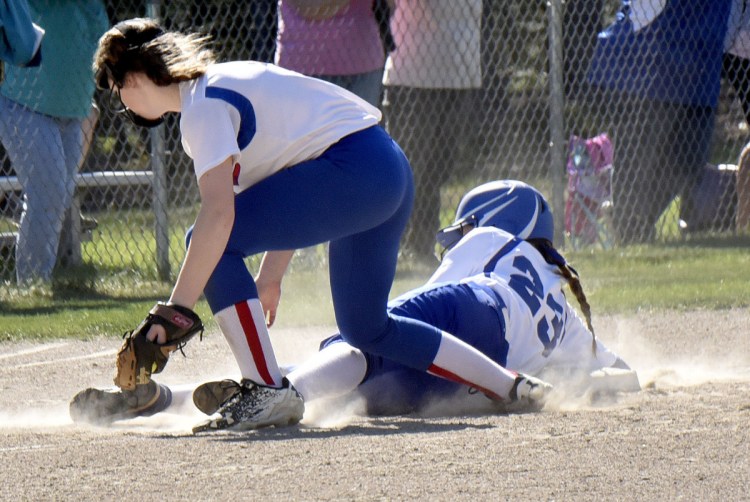Madison baserunner Katie Worthen slides safely into third base as Oak Hill's Julia Noel fields the ball during a Mountain Valley Conference game Monday in Madison.