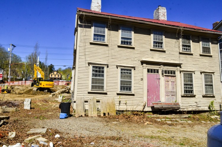 Workers from MainEx dig a basement hole at the corner of the Central and Second streets on May in Hallowell. The Dummer House, in background, will be moved there in a few weeks and the space on Dummer's Lane will become parking.