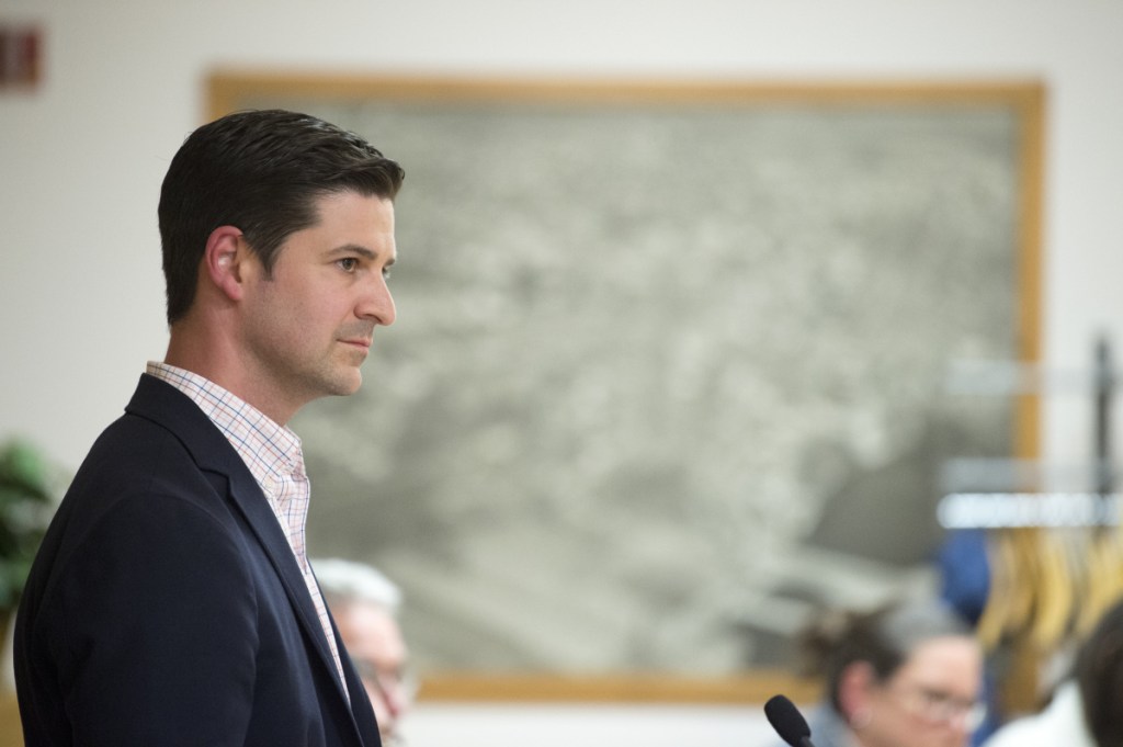 Mayor Nick Isgro listens to remarks by Hank Poirier supporting him Tuesday during a Waterville City Council meeting in the council chamber.