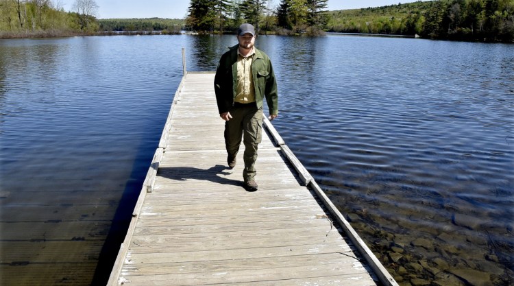 Lake George Regional Park resource manager Justin Spencer walks off the boat ramp Wednesday after inspecting it for the upcoming season at the east side of the park in Canaan. Spencer served two combat tours in Afghanistan and studies conservation law enforcement at Unity College.