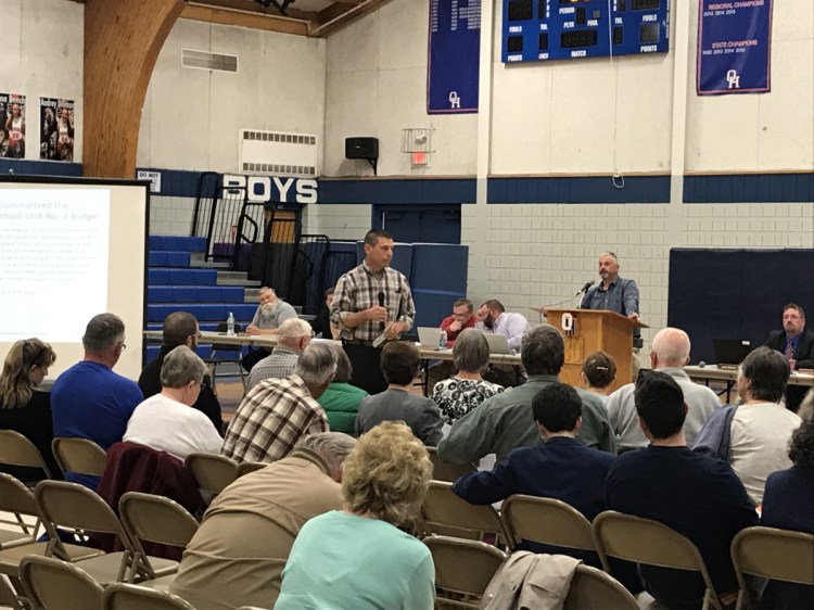 Litchfield resident Dave Lary speaks at the district budget meeting of Regional School Unit 4 on Wednesday at Oak Hill High School. Lary expressed frustration with the district's funding formula, which he said places an unfair amount of the tax burden on Litchfield.
