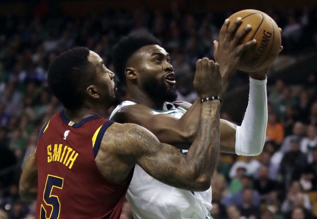 Boston Celtics guard Jaylen Brown, right, tries to drive against Cleveland Cavaliers guard JR Smith (5) during the second half of Game 2 of the Eastern Conference finals on Tuesday in Boston.
