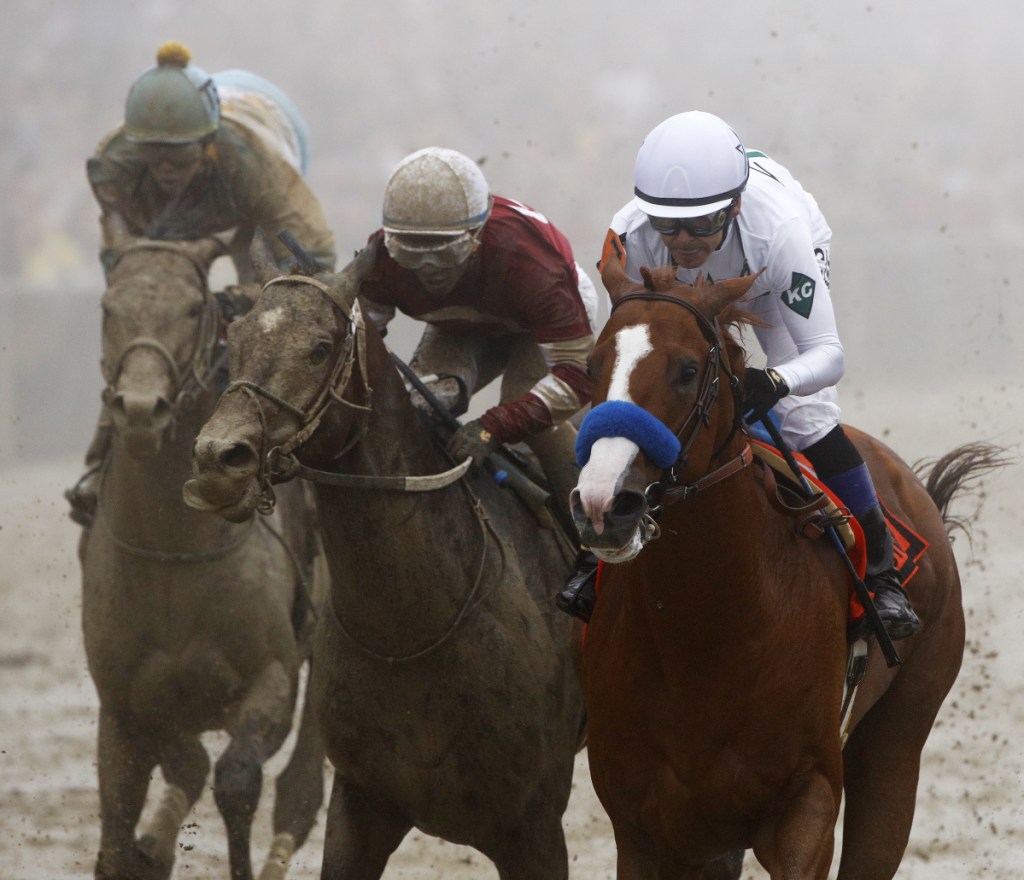 Justify with Mike Smith atop, right, wins the 143rd Preakness Stakes on Saturday at Pimlico race track in Baltimore. Justify will have a shot at the Triple Crown at the upcoming Belmont Stakes.