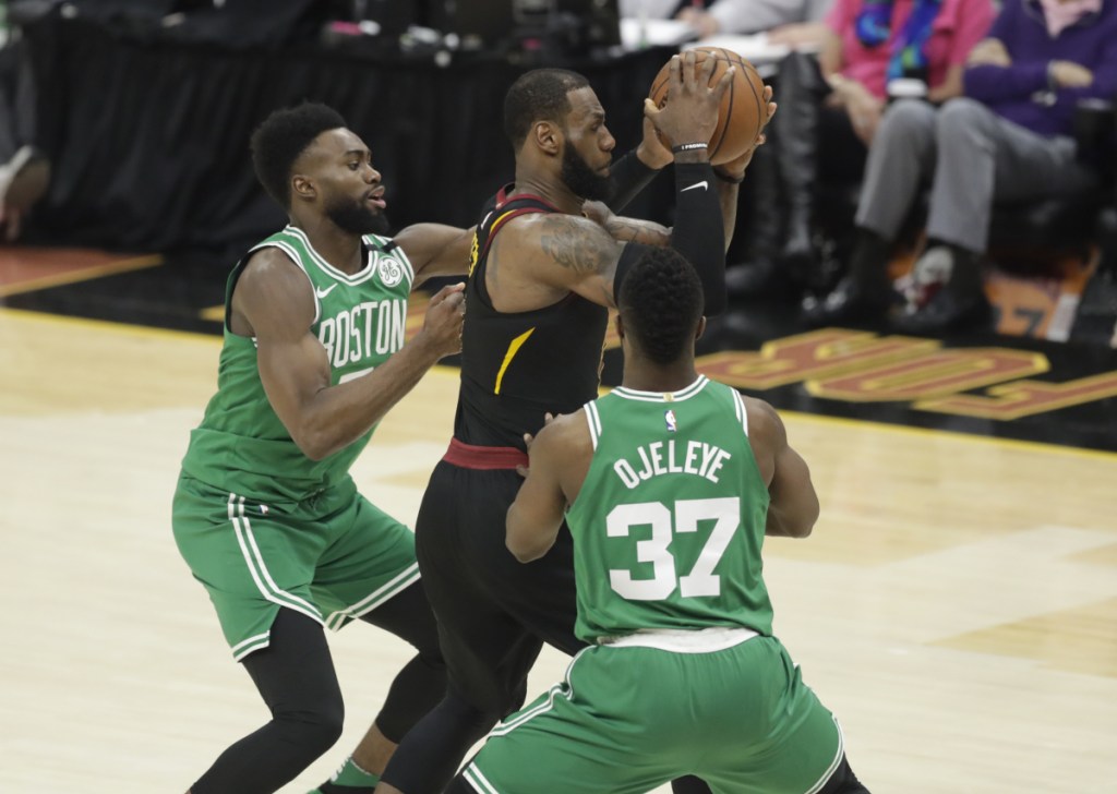 Boston's Semi Ojeleye (37) and Jaylen Brown, left, double-team Cleveland Cavaliers forward LeBron James, center, in the second half of Game 3 of the NBA Eastern Conference finals on Saturday in Cleveland.
