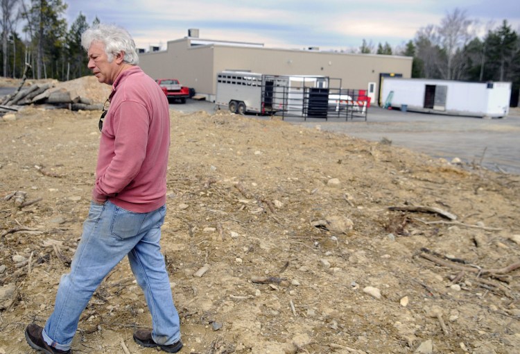 Central Maine Meats partner Joel Davis walks on April 18, 2016, to what he planned to develop as pens for the firm's slaughterhouse in Gardiner. Davis is now suing his former business partner, Bill Lovely, alleging fraudulent business dealings against him.