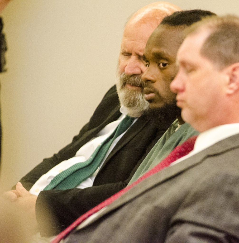 Translator John Roy, left, Aubrey Armstrong and defense attorney Brad Grant listen to the state's closing argument on Tuesday at the Capital Judicial Center in Augusta. Armstrong, charged with murder, has been using an interpreter to translate between English and Guyanese Creole.