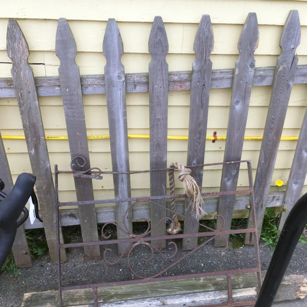 A picket fence and small metal gate section, knocked over by a vehicle this past weekend, was moved and leaned against Slates Restaurant in Hallowell on Tuesday.