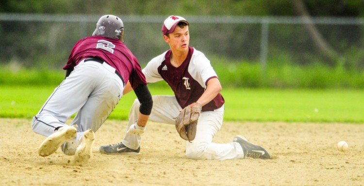 Richmond baserunner Matt Rines, left, dives back to second base in time to beat the throw to Buckfield second baseman Dylan Harvey during a game Tuesday on the Gerald N. Seigars Memorial Baseball Field in Richmond.