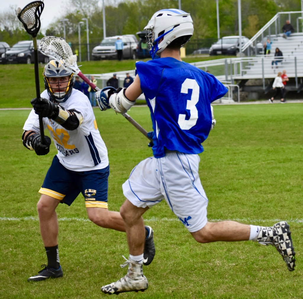 Morse's Don Green tries to race by Dominique Giampietro (32) in a lacrosse game at Caldwell Field in Farmington on Tuesday afternoon.