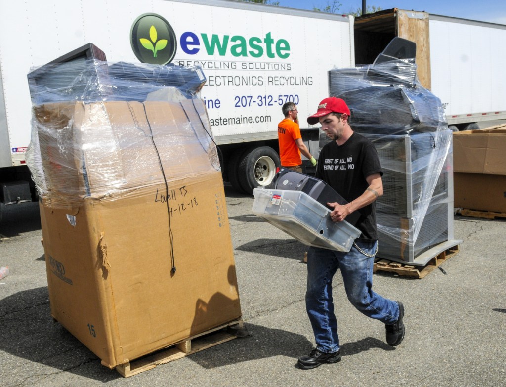 Volunteer Brad Hanley carries a tote of old computers during an e-waste recycling event on Saturday in the Augusta Civic Center parking lot. People made donations to drop off items and the event was a fundraiser for Bridging The Gap, which runs the Augusta Warming Center, Addie's Attic and Basic Essentials Pantry. The group wants to move its social services to the Emmanual Lutheran Episcopal Church on Eastern Avenue in Augusta.