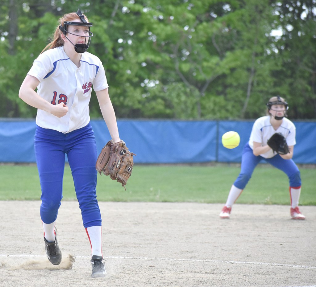 Oak Hill starting pitcher Sadie Waterman delivers a pitch while second baseman Emily Ahlberg looks on during a win over Spruce Mountain in Wales on Wednesday.