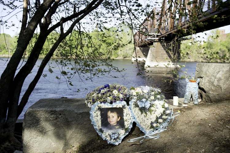 A picture of 5-year-old Valerio McFarland rests near where he fell into the Androscoggin River on April 24.