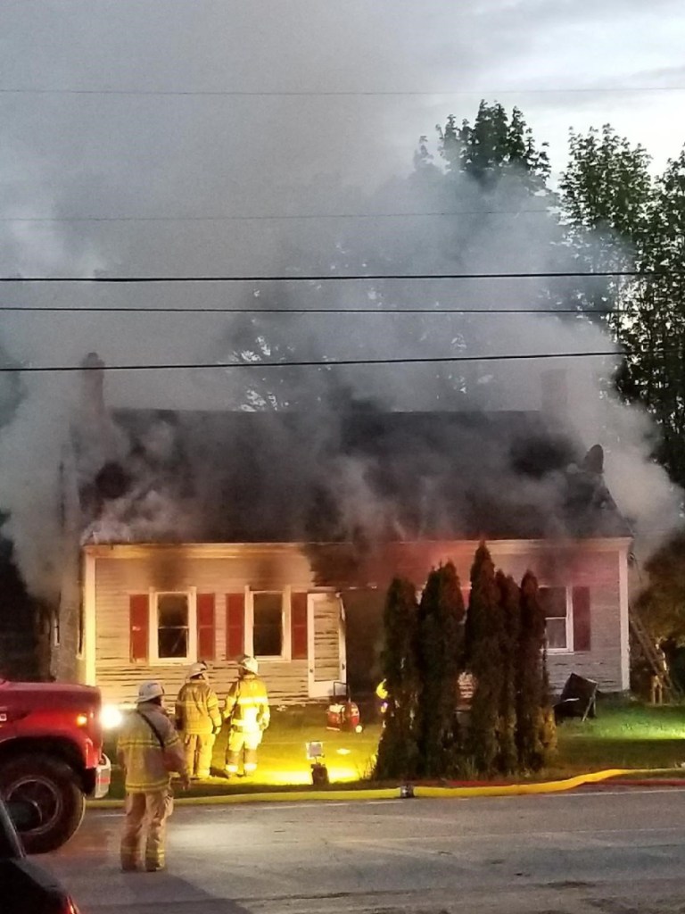 Smoke billows from the home at 114 Belgrade Road early Sunday morning. Neighbors say they were awakened around 4 a.m., to find the home of their neighbors, Kevin and Allison Sanborn, on fire. They say the Sanborns, their two sons and pets were able to get out of the home.