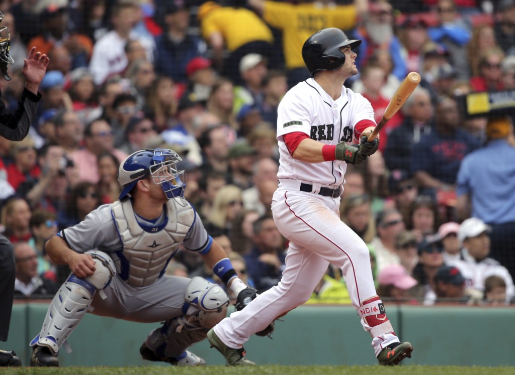 Boston's Andrew Benintendi, right, watches his three-run home run in front of Toronto catcher Luke Maile in the fourth inning Monday at Fenway Park in Boston.