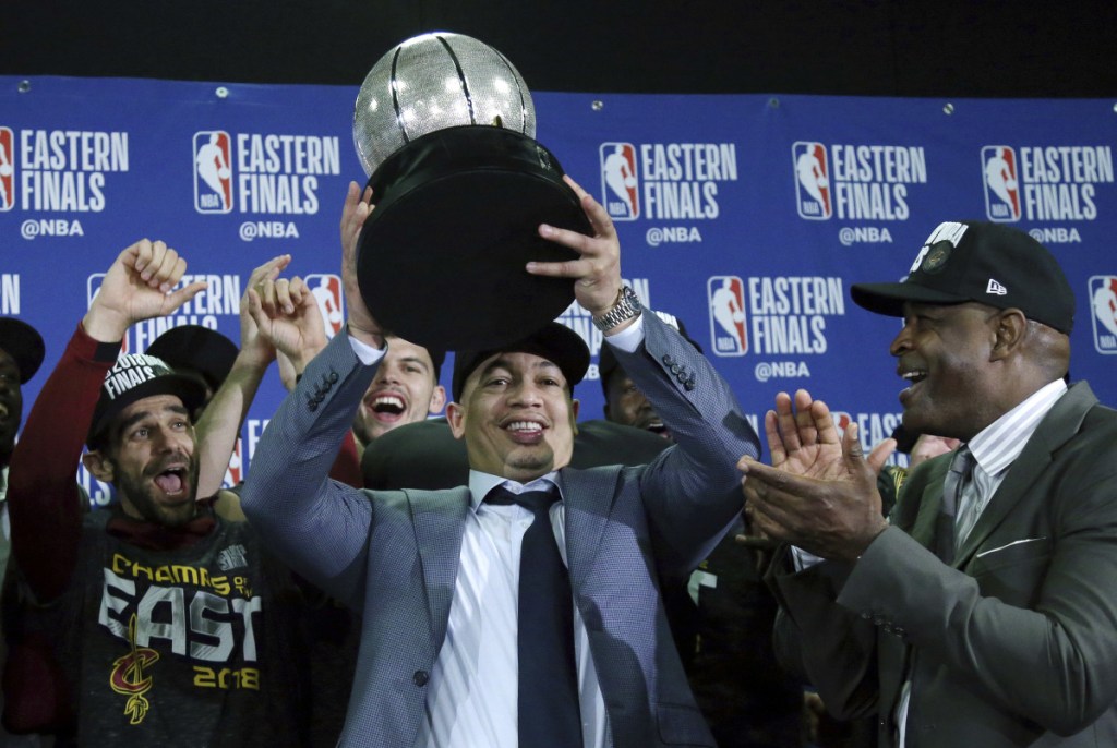 Cleveland Cavaliers head coach Tyronn Lue hoists the trophy after beating the Boston Celtics 87-79 in Game 7 of the Eastern Conference Finals on Sunday in Boston.