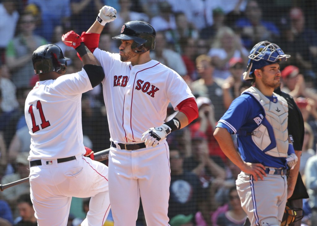 Boston's J.D. Martinez celebrates his two-run home run with teammate Rafael Devers (11) in front of Toronto Blue Jays catcher Luke Maile in the sixth inning Wednesday at Fenway Park in Boston.