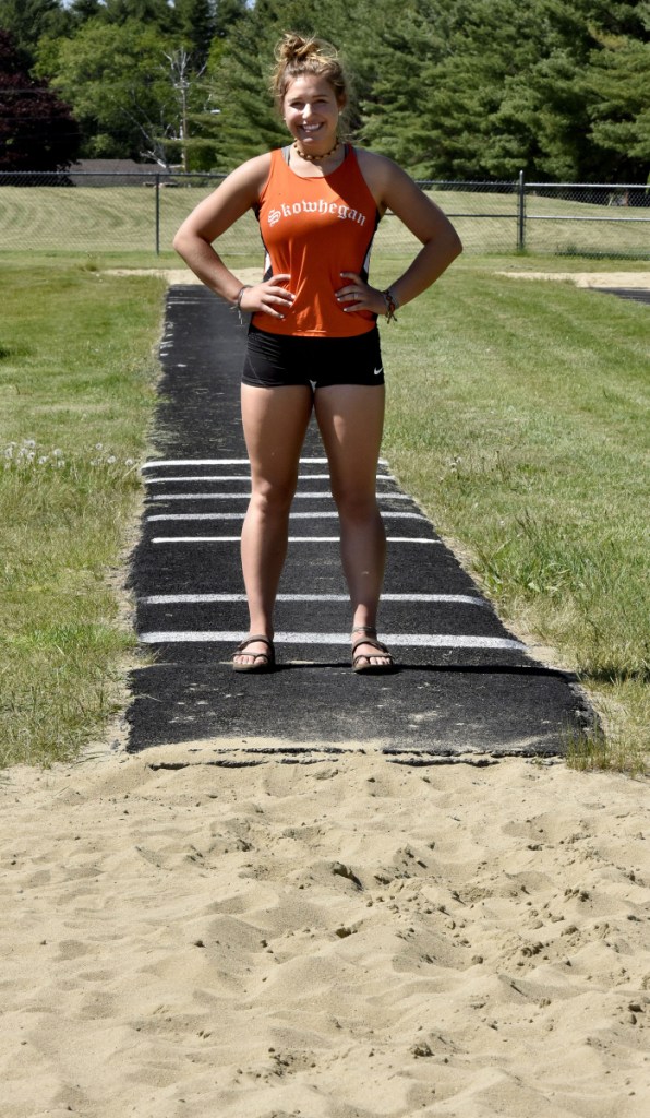 Skowhegan's Leah Savage stands where the triple jump runway and pit meet at the high school on Wednesday. Savage is a contender for the Class A triple jump title.