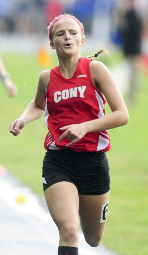 Cony's Julia Reny runs the 800 meters during a rainy Kennebec Valley Athletic Conference track and field championships last Saturday in Topsham.