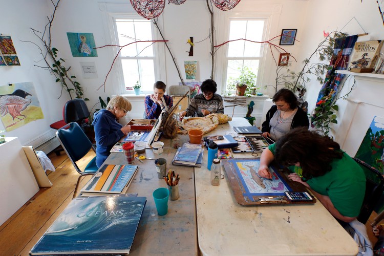 A group of artists and a mentor are hard at work at Spindleworks, an art studio for people with intellectual disabilities. The studio is an example of a service whose funding has suffered from the Legislature's adjournment that left important business unfinished. Clockwise from left: Grace McKenna, artist mentor Julianne Carle, Lidia Woofenden, McKensy Brown and Barbara Welborn. 