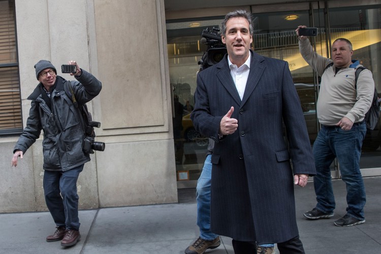 Attorney Michael Cohen gives photographers the thumbs up as he walks in New York on Wednesday. Federal prosecutors say in a court filing Friday that the criminal probe that led them to raid Cohen's offices is focused on his "personal business dealings."