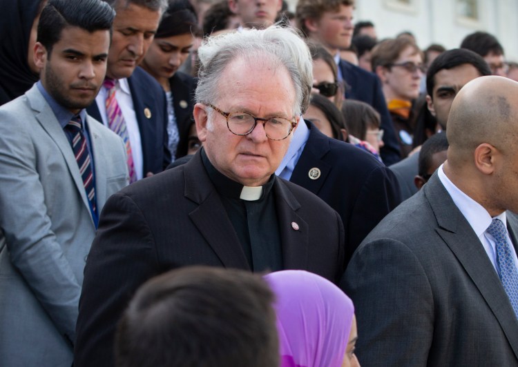 Rev. Patrick Conroy, chaplain of the House of Representatives, delivers an interfaith message on June 13, 2016, on the steps of the Capitol in Washington for the victims of the mass shooting at Pulse nightclub in Orlando. Conroy, the embattled chaplain of the House of Representatives is seeking to withdraw his resignation in an explosive letter to House Speaker Paul Ryan. Conroy accuses a top Ryan aide of telling him “something like ‘maybe it’s time that we had a Chaplain that wasn’t a Catholic.’” Conroy says he has never “heard a complaint about my ministry” as House chaplain.