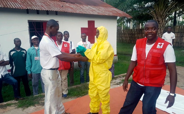 Members of a Red Cross team don protective clothing before heading out to look for suspected victims of Ebola, in Mbandaka, Congo on May 14. 