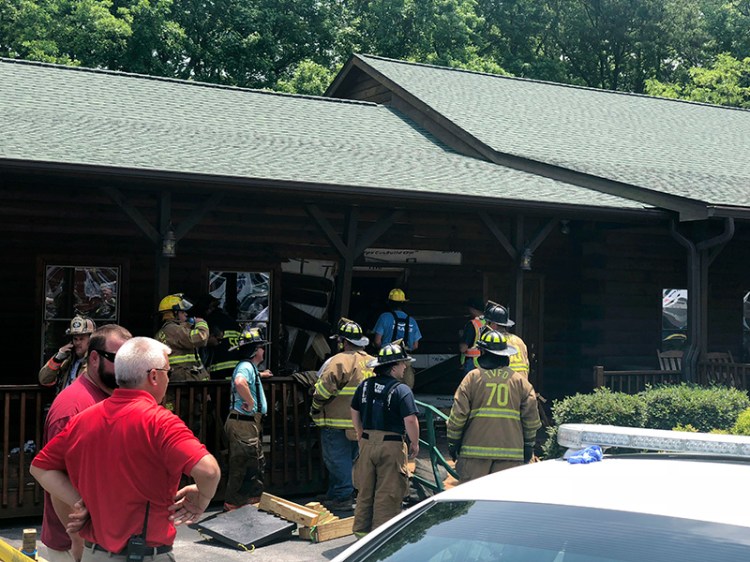 Authorities work the scene of a restaurant where police say a man intentionally rammed a vehicle into the building midday Sunday in Bessemer City, N.C.