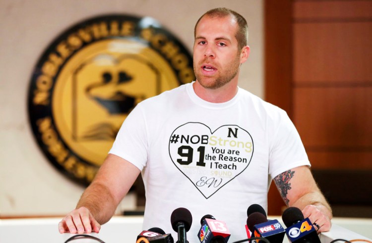 At Monday's news conference, Jason Seaman wore a T-shirt with the message: "#NOB Strong. You are the reason I teach," along with the initials of a wounded student, EW.