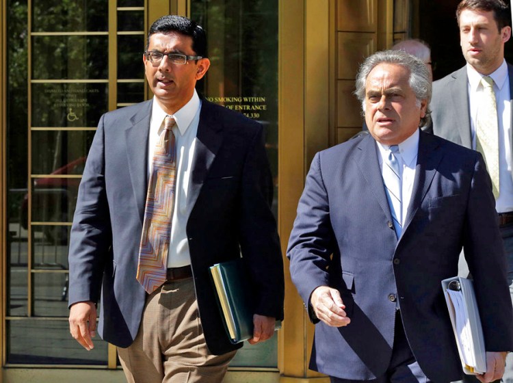 Conservative commentator and filmmaker Dinesh D'Souza, left, is accompanied by his lawyer Benjamin Brafman as they leave federal court in New York on May 20, 2014. 