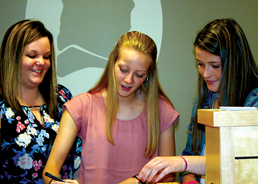 At the Mt. Blue campus, one part of the business program at the Foster Regional Applied Technology Center is a real bank branch. Branch Coordinator Haily Turner supervises seniors Madison Ladd (center) and Gracie Foss (right), as they process transactions on a Monday morning. In past 25 years of the unique school-business partnership, students have graduated fully prepared for a real-world job in banking. Ladd said she has chosen to continue as a Franklin Savings Bank employee. Other students work as interns at Franklin Savings Bank, while many continue their secondary education in finance-related fields, often with the help of the bank’s scholarship program.  Photo by Valerie Tucker