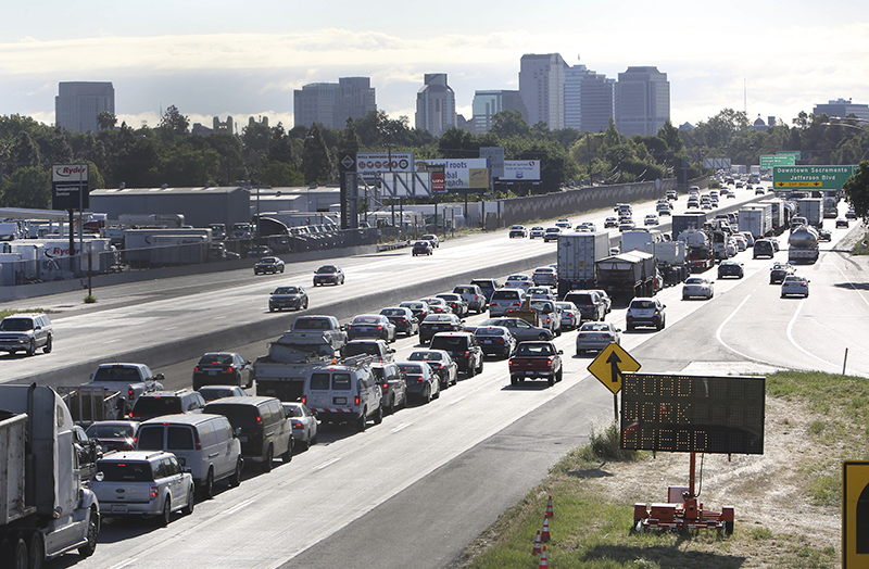 FILE - In this April 22, 2014 file photo, drivers enter Sacramento on Highway 50 to come to a near stand still as traffic backs up in West Sacramento, Calif. California and 16 other states sued the Trump administration on Tuesday, May 1, 2018, over its plans to scrap standards on vehicle greenhouse gas emissions, which help set gas mileage rules.(AP Photo/Rich Pedroncelli, File)