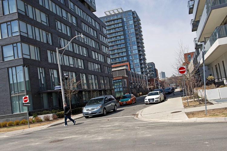 Condominiums are seen along Sackville Street at the Regent Park housing project in Toronto. The average annual income needed to purchase an average-priced resale condo in the city is about $77,000 (U.S.), up from $60,000 a year earlier, according to Urbanation Inc. In the rental market, average monthly rents surged about 11 percent in the first quarter, to $1,751.