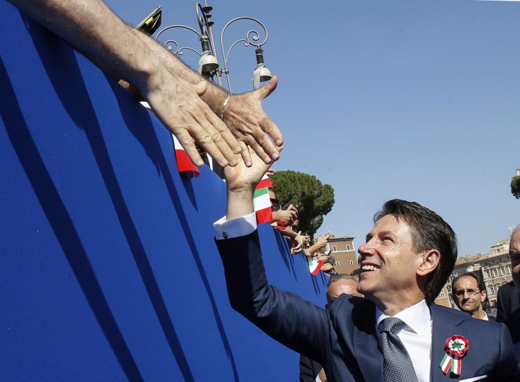 Italian Premier Giuseppe Conte is cheered by citizens during the country's Republic Day in Rome on Saturday. National pride was on display after Italy ended three months of political turmoil and swore in officials whose euro-skeptic and populist leanings have alarmed Europe.