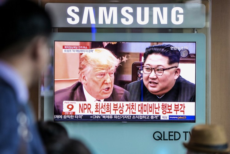 People watch a television screen broadcasting a news report featuring images of President Trump and North Korean leader Kim Jong Un in Seoul, South Korea, last month.