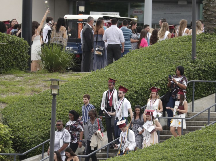 People leave a graduation ceremony for Marjory Stoneman Douglas seniors Sunday in Sunrise, Fla. The class from the high school where a gunman killed 17 people in February heard from surprise commencement speaker Jimmy Fallon, who urged the graduates to move forward.
