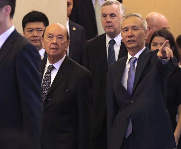 U.S. Commerce Secretary Wilbur Ross, front eft, and Chinese Vice Premier Liu He, right, arrive at a meeting at the Diaoyutai State Guesthouse in Beijing on Sunday. 